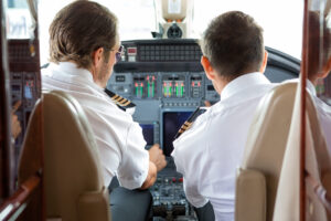 Pilot And Copilot In Private Jet Cockpit
